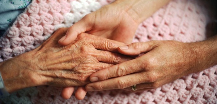 Holding Hands with Elderly Patient