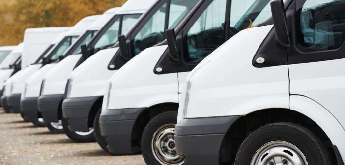 commercial delivery vans in row at parking place of transporting