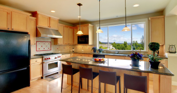 Luxury classic wood kitchen with island and chairs.