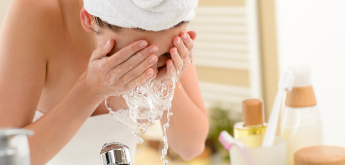 Skin Rejuvenation: Best Ways to Get Youthful, Glowing Skin Woman splashing face with water in bathroom