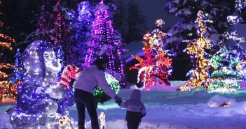 A mother and child look at a decorative bear at a country house estate in the village of Grabovnica