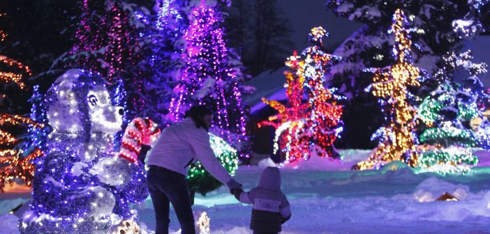 A mother and child look at a decorative bear at a country house estate in the village of Grabovnica