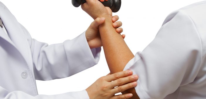 Doctor holding patient 's elbow for rehab weight training